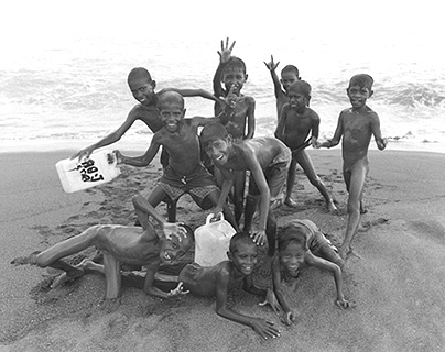  shows a group of naked boys on a beach near Suai East Timor in 2000